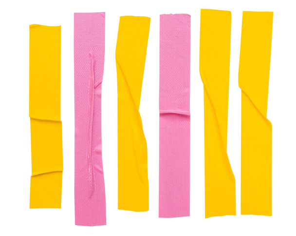 Top view set of pink and yellow wrinkled adhesive vinyl tape or cloth tape in stripes shape is isolated on white background with clipping path. - Photo, Image