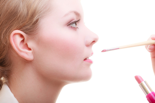Woman applying red lipstick - Фото, изображение