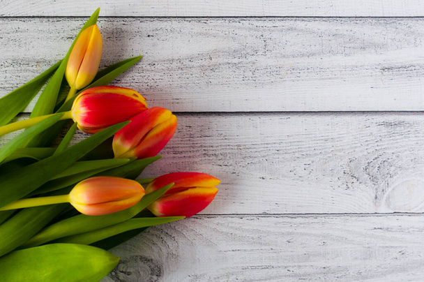 Un bouquet di tulipani colorati su un tavolo di legno - Foto, immagini
