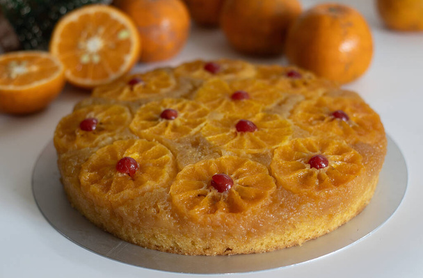 Orange upside down cake, also known as citrus caramel cake or caramelized orange cake. Variety of upside down cake with orange slices. Moist, flavorful dessert, perfect for baking enthusiasts. - Photo, Image