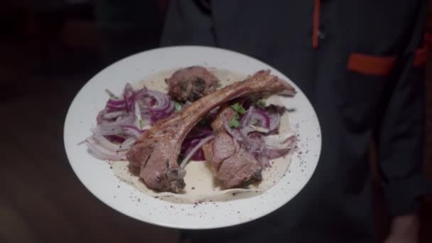 Piatto contenente carne e cipolle come parte di una preparazione di pasti. - Filmati, video