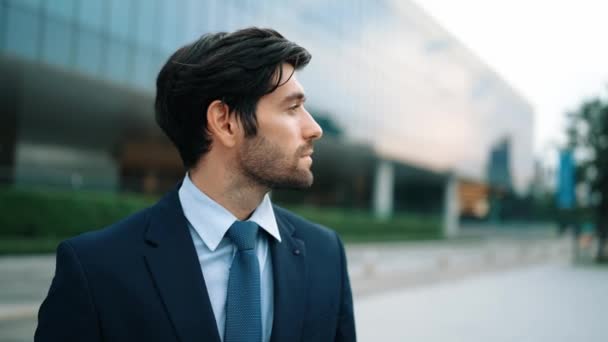 Skilled smiling business man looking at camera while standing at building. Closeup of successful man smiling at camera while wearing business suit. Happy manager look at camera. Business. Exultant. - Footage, Video