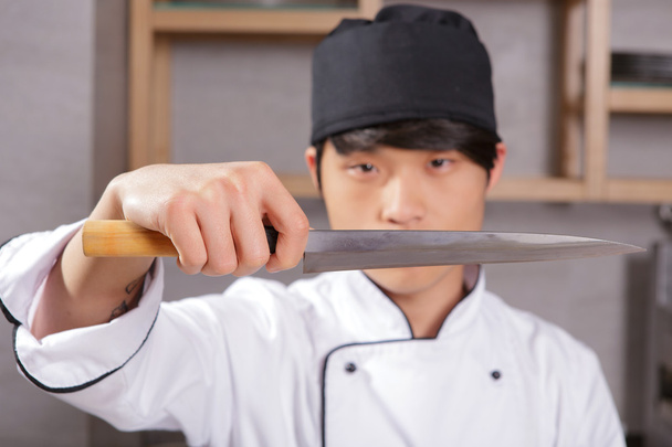 Cook shows sharp knife - Φωτογραφία, εικόνα