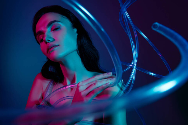 Фото жінки з закритими очима торкаються пальців плеча об'ємні пластикові кабелі краси ізольовані ультрафіолетовий фон. - Фото, зображення