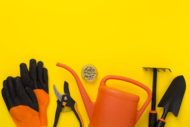 Orange gardening tools on color background, top view - Photo, Image