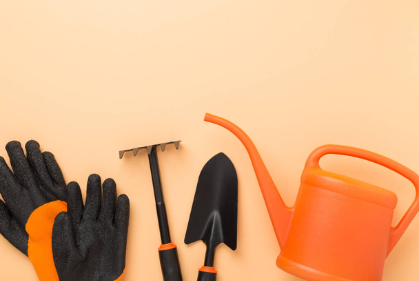 Orange gardening tools on color background, top view - Photo, Image