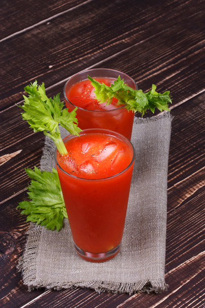Bloody mary cocktails served with celery on wooden background - Φωτογραφία, εικόνα