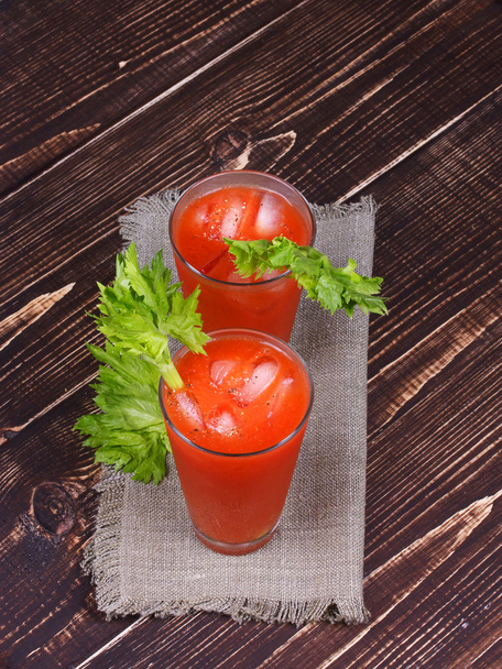 Bloody mary cocktails served with celery on wooden background - Φωτογραφία, εικόνα