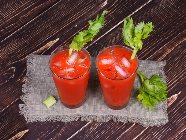 Bloody mary cocktails served with celery on wooden background - Fotografie, Obrázek