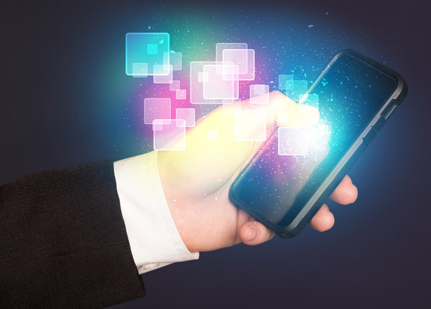 Ruka držící chytrý telefon s abstraktní zářící čtverce - Fotografie, Obrázek