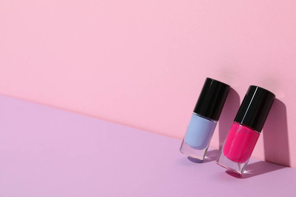 Veelkleurige nagellakken op een roze achtergrond - Foto, afbeelding