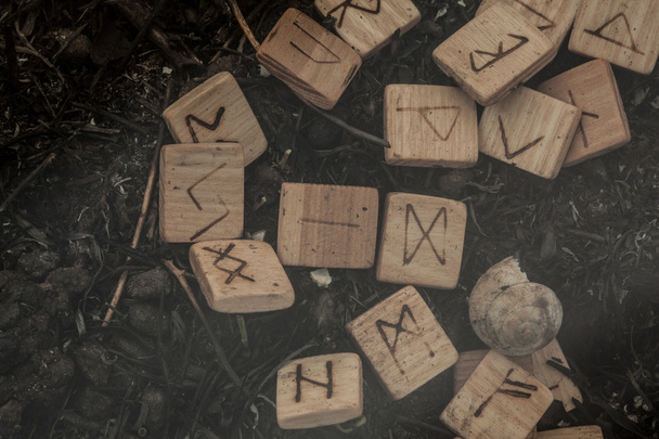 Wooden runes on the ground - 写真・画像