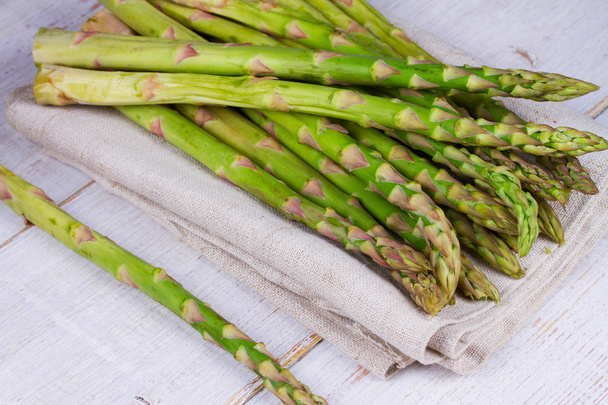 Asparagus on wooden background - Фото, изображение