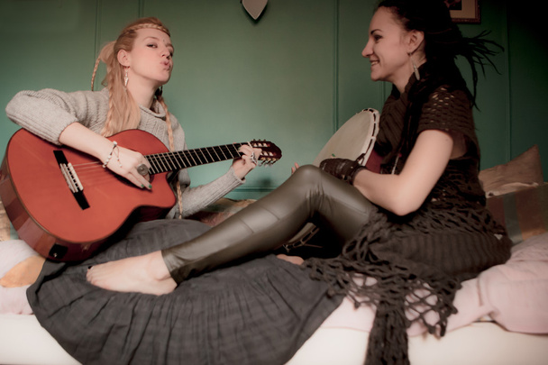 two beautiful woman with  tambourine and guitar - Zdjęcie, obraz