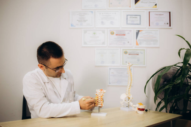 Professional orthopedist at table in medical office. High quality photo - Photo, Image