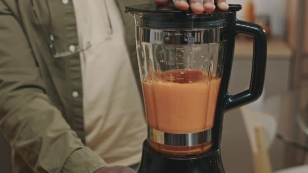 Cropped shot of mature African American man making detox smoothie in blender at home - Footage, Video