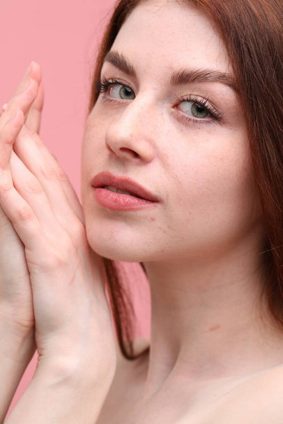 Portrait of beautiful woman with freckles on pink background, closeup - Φωτογραφία, εικόνα