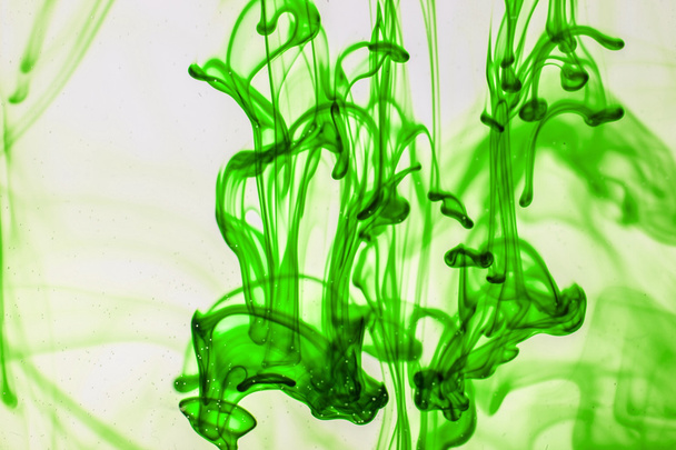 Green liquid ink in water making abstract forms - Fotoğraf, Görsel