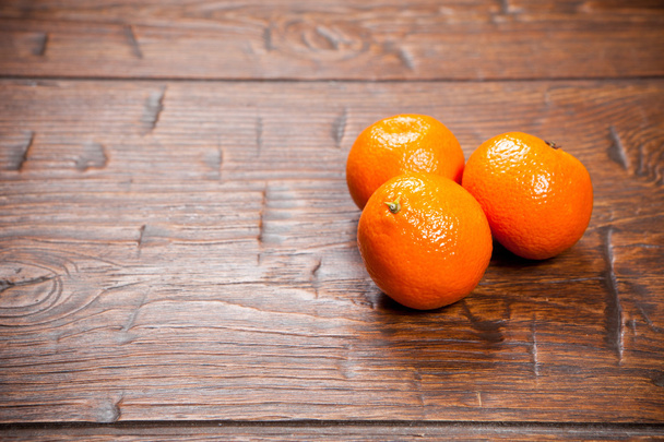 Tangerines on wooden table - Фото, изображение