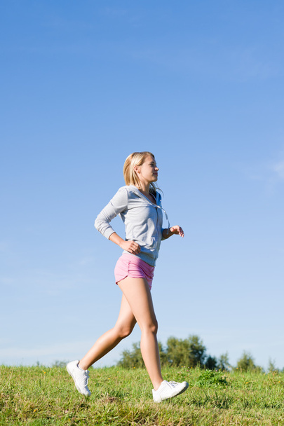 Jogging young sportive woman meadows sunny day - Foto, afbeelding