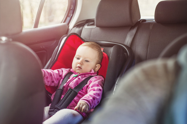 Baby girl in a child seat - Foto, Imagen