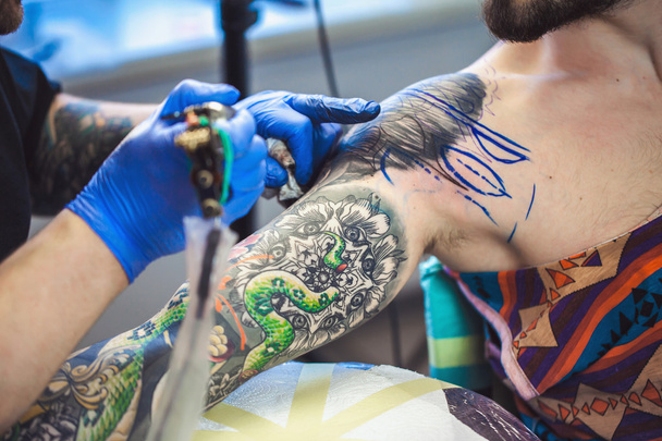Tattooist makes a tattoo - Photo, Image