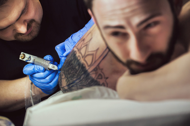 Tattooist makes a tattoo - Photo, image