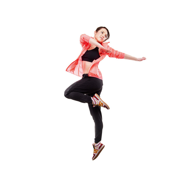nowoczesny styl tancerz pozowanie hodling nogi na tle studio - Zdjęcie, obraz