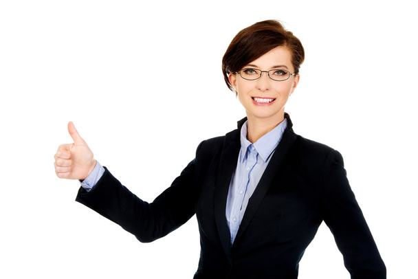 Smiling businesswoman with thumbs up. - Фото, изображение