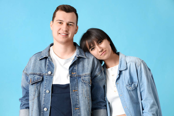Young couple in love on blue background - Foto, imagen