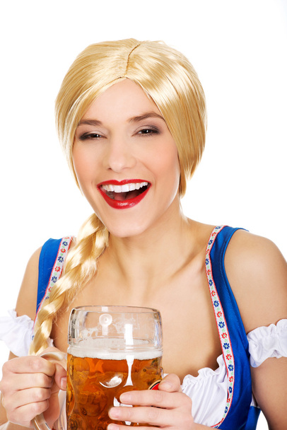 Beautiful bavarian woman with beer. - Photo, image