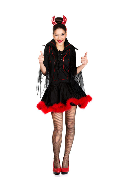 Woman in devil costume with thumbs up. - Foto, Imagen