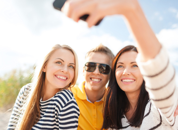 group of friends taking selfie with cell phone - Fotó, kép