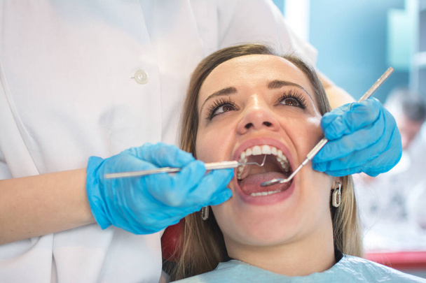 Zubař vyšetření zubů pacientů v zubní ordinaci. - Fotografie, Obrázek