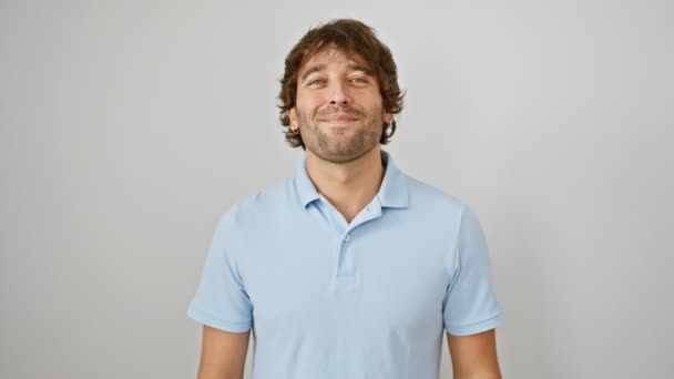 Confident and attractive young caucasian man, standing proudly with a bright, cool smile on his face, showing teeth, radiating joy on an isolated white background. - Footage, Video