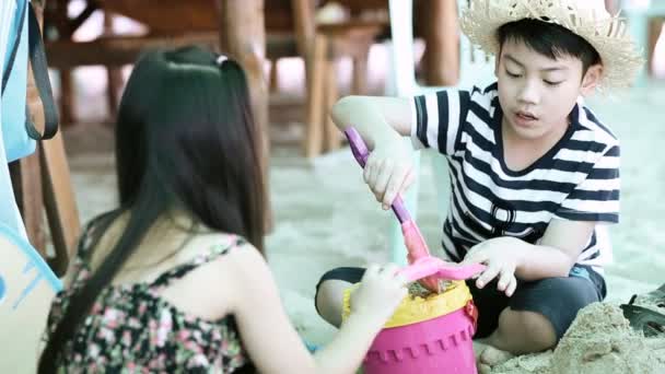 Szczęśliwy azjatyckich dzieci gry piasku na plaży - Materiał filmowy, wideo