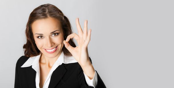 Happy businesswoman with okay gesture, with copyspace - Photo, Image