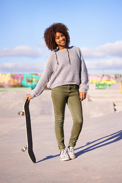 Portrait, smile and woman with skateboard on street in city in summer for sport, health and exercise outdoor. Happy person, skate park and gen z girl in casual clothes for fashion in South Africa. - Фото, зображення