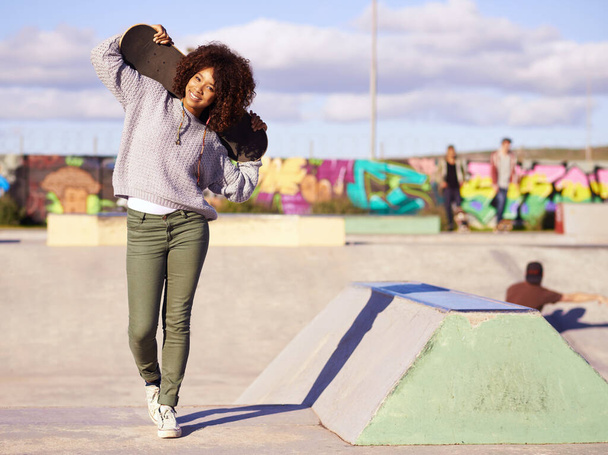 Skatepark, fashion and portrait of black woman with skateboard in city for skating, training and hobby. Skater, happiness and face of female person for trendy, edgy and hipster clothing in town. - Photo, image