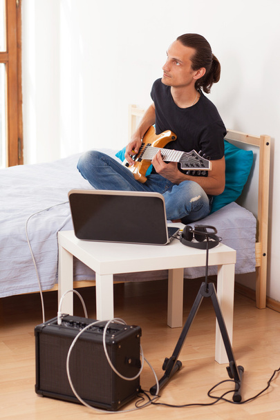 Young man playing electric guitar at home - Photo, Image