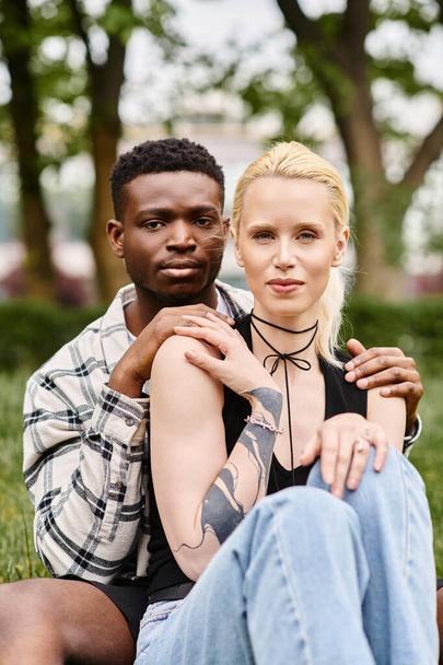 Multicultural couple, African American man and Caucasian woman in a park. - Photo, Image