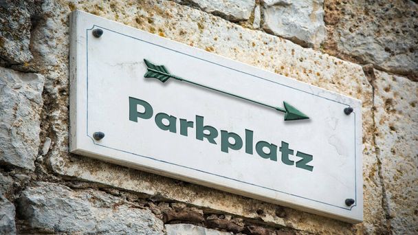 An image with a signpost in German pointing towards the parking lot. - Photo, Image