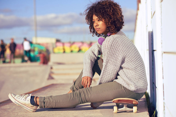 Woman, thinking and skateboard in city for skate, recreation and idea for break in urban for summer, fun and holiday. African person and relax with wheels for trendy, active and watching on mockup. - Zdjęcie, obraz
