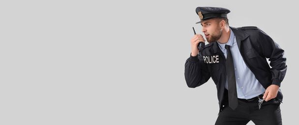 Férfi rendőrtiszt walkie-talkie világos háttérrel helyet szöveges - Fotó, kép