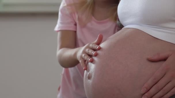 Vorschulmädchen berührt Bauch ihrer schwangeren Mutter - Filmmaterial, Video