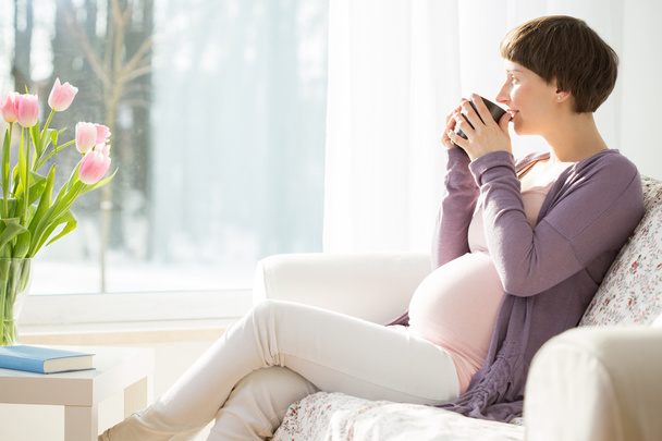 Pregnant woman drinking tea - Fotó, kép