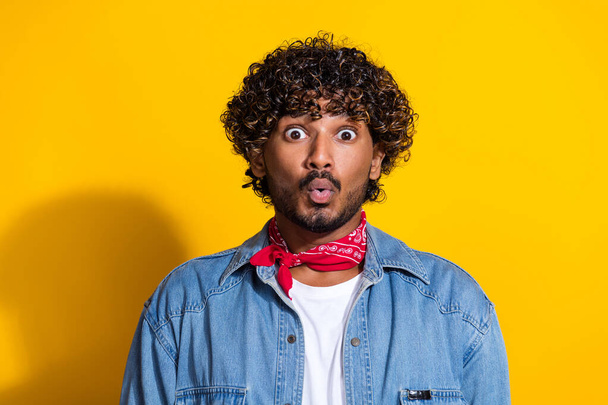 Photo portrait of nice young male shocked face pouted lips wear trendy denim outfit red scarf isolated on yellow color background. - Fotó, kép