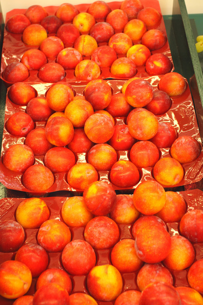 Crate of nectarines walls on a market stall - Photo, image