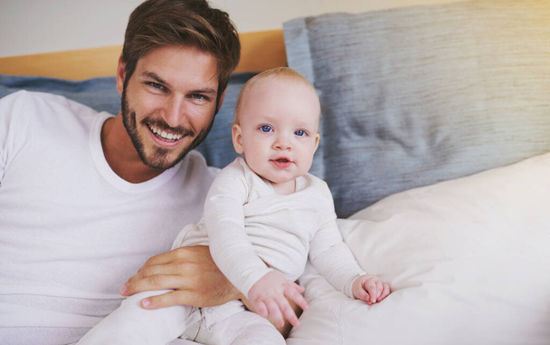 Bedroom, happy and portrait of father with baby for bonding, relationship and love for parenting. Family, home and dad with newborn infant on bed for child development, support and childcare in house. - Photo, Image