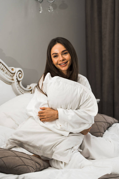Młoda piękna kobieta budzi się w jasnym pokoju hotelowym.Morning szczęśliwy woman.Hotel koncepcji wakacje - Zdjęcie, obraz